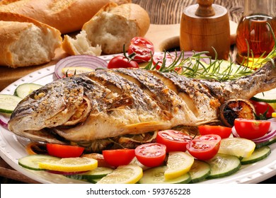 Grilled Fish With Baguette And Vegetables On White Plate


