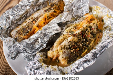 Grilled Fish With Herbs And Lemon On Aluminium Foil. Close-up.