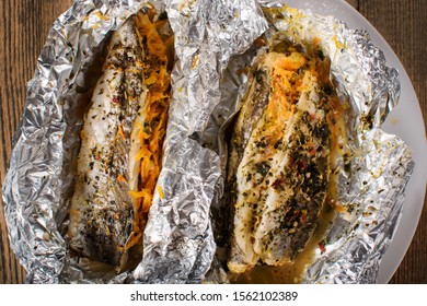 Grilled Fish With Herbs And Lemon On Aluminium Foil. Close-up.