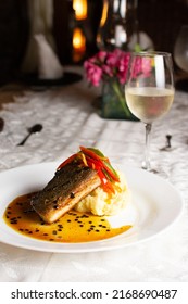 Grilled Fish Loin On Mashed Potatoes And Passion Fruit Sauce