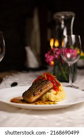 Grilled Fish Loin On Mashed Potatoes And Passion Fruit Sauce