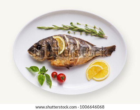 Grilled fish on plate isolated on white background. Cutout and mockup for restaurant menu, top view