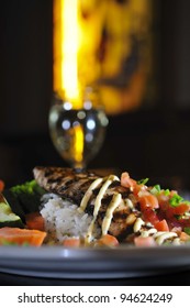 Grilled Fish On A White Plate With Rice And Vegetables Glass Of Wine