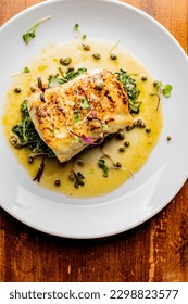 Grilled fish. Grilled red snapper. Traditional Classic American or French Seafood Restaurant menu item, whole grilled fresh caught halibut or sea bream Fish served with chilled gazpacho and peppers. - Shutterstock ID 2298823577