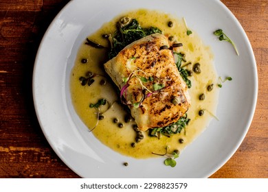Grilled fish. Grilled red snapper. Traditional Classic American or French Seafood Restaurant menu item, whole grilled fresh caught halibut or sea bream Fish served with chilled gazpacho and peppers. - Shutterstock ID 2298823579