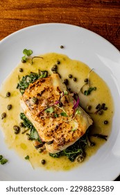 Grilled fish. Grilled red snapper. Traditional Classic American or French Seafood Restaurant menu item, whole grilled fresh caught halibut or sea bream Fish served with chilled gazpacho and peppers. - Shutterstock ID 2298823589