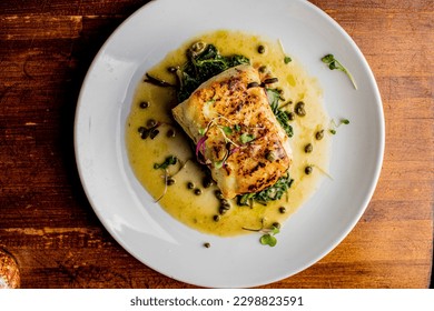 Grilled fish. Grilled red snapper. Traditional Classic American or French Seafood Restaurant menu item, whole grilled fresh caught halibut or sea bream Fish served with chilled gazpacho and peppers. - Shutterstock ID 2298823591