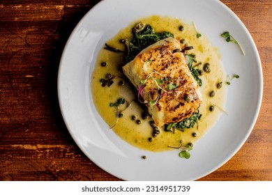Grilled fish. Grilled red snapper. Traditional Classic American or French Seafood Restaurant menu item, whole grilled fresh caught halibut or sea bream Fish served with chilled gazpacho and peppers. - Shutterstock ID 2314951739