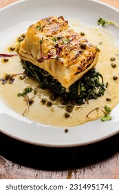 Grilled fish. Grilled red snapper. Traditional Classic American or French Seafood Restaurant menu item, whole grilled fresh caught halibut or sea bream Fish served with chilled gazpacho and peppers. - Shutterstock ID 2314951741