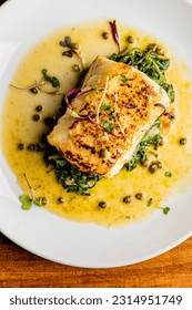 Grilled fish. Grilled red snapper. Traditional Classic American or French Seafood Restaurant menu item, whole grilled fresh caught halibut or sea bream Fish served with chilled gazpacho and peppers. - Shutterstock ID 2314951749