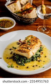 Grilled fish. Grilled red snapper. Traditional Classic American or French Seafood Restaurant menu item, whole grilled fresh caught halibut or sea bream Fish served with chilled gazpacho and peppers. - Shutterstock ID 2314951763