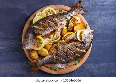 Grilled Fish With Roasted Potatoes, Lemon And Rosemary On Wooden Tray. View From Above, Top