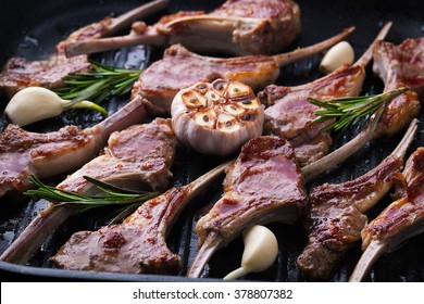 Grilled fresh lamb meat ribs with spices, garlic and rosemary in a pan grill