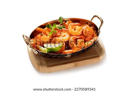 Grilled fresh Spicy  Prawns Shrimps with lime and oregano in serving pan. isolated on white background