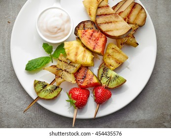 Grilled Fruits On Wooden Skewers And Yogurt Sauce, Top View