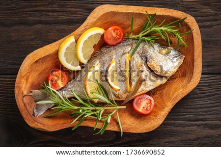 Grilled gilt-head bream  with lemon. and rosemary. 