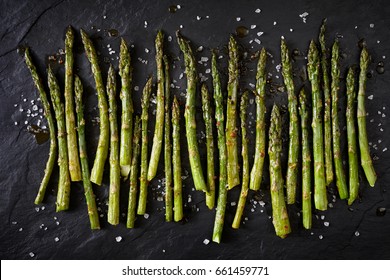 Grilled Green Asparagus On Black Stone Background, Top View