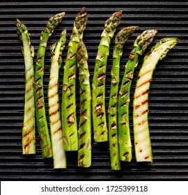 Grilled Green Asparagus On A Cast Iron Plate, Top View