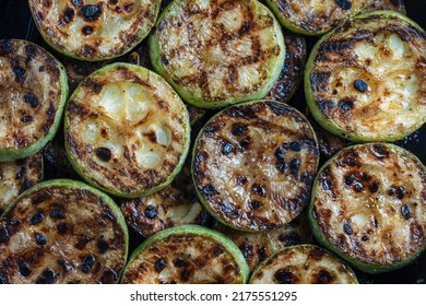 Grilled green organic zucchini with spices, healthy vegetarian food, close up, top view