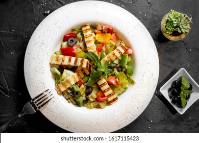 Grilled Halloumi Salad On White Dish 