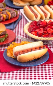 Grilled Hot Dog On A Table Set For An American BBQ With Red White And Blue