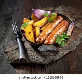 grilled, juicy sausages in a pan on a wooden background. rustic style.