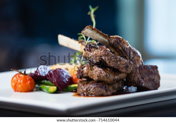 Grilled lamb carre with warm\
couscous salad, roasted vegetables, Dijon mustard and red wine\
sauce