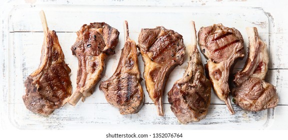 Grilled Lamb Ribs. Rack Of Lamb Chop On White Wooden Board. Top View