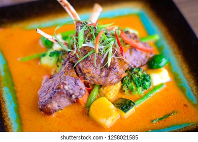 Grilled Lamb Shank With Grilled Vegetables On A Bed Of Mild Curry