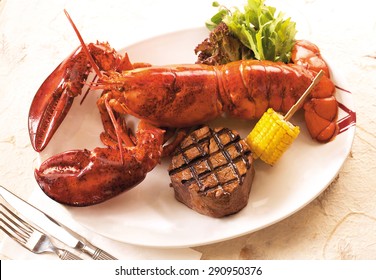 Grilled Lobster And Beef Steak On Dinner Plate