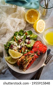 Grilled Lobster Tail Served With Fresh Greek Salad With Sliced Lemon And Melted Butter For Dipping