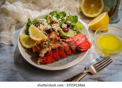 Grilled Lobster Tail Served With Fresh Greek Salad With Sliced Lemon And Melted Butter For Dipping