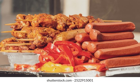 Grilled marinated meat skewers, along with sausages, peppers and tomatoes for hot dogs. Fast food at a street vendor at the World Trade Center in New York, USA. 2019. - Powered by Shutterstock