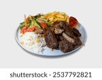 Grilled meat assortment with pepper, grilled potato, tomato and greens