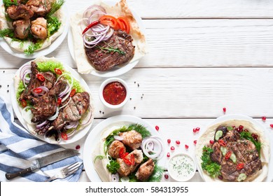 Grilled Meat Meals On Table Flat Lay. Top View On Assortment Of Tasty Bbq Snacks, Free Space On White Wooden Background. Restaurant Menu, Buffet, Lunch Concept