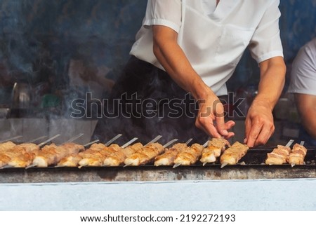 grilled meat on coals in a cafe in uzbekistan. barbecue on the grill in a tourist place. frying sheep meat on wood in tashkent