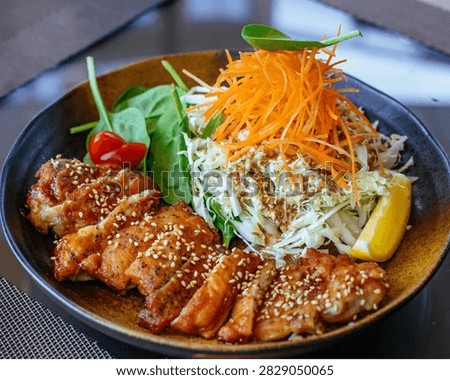 Grilled meat with rice, vegetables and side dishes served on a plate, creating a delicious and colorful complete meal.