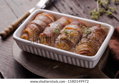 Grilled meat rolls wrapped in strips of bacon. Pork roll filled