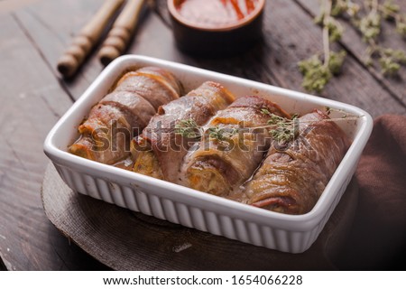 Grilled meat rolls wrapped in strips of bacon. Pork roll filled