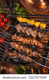  Grilled meat. Shish kebab.  Eastern fast food. Mix kebab meat, chicken, lamb, beef. Grilled meat skewers on rustic wooden table. Restaurant menu, advertisement, banner, poster