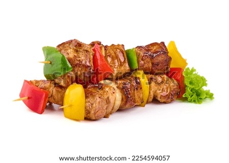 Grilled meat skewers, roasted shish kebab with onion and tomatoes, isolated on white background