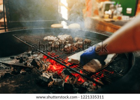 Similar – Man cooking on a barbecue