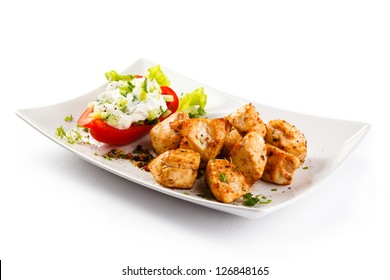 Grilled meat and vegetables on white background