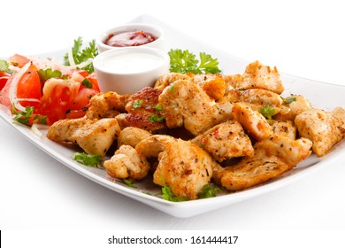Grilled meat and vegetables on white background 