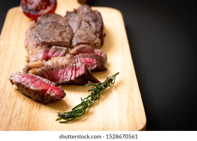 Grilled Medium Rare Beef Steak On Wood Board