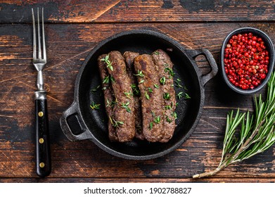 Grilled Mince Meat Sausages In A Pan. Dark Wooden Background. Top View.