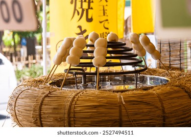 Grilled Mitsufuku Dango Skewers Being Prepared at a Street Stall (With the Vertical Sign of "Grilled Dango"), Kamakura, Japan, August 2024 - Powered by Shutterstock