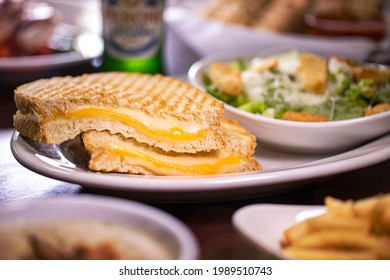 Grilled Mozzarella Provolone Cheddar Cheese Toasted Sliced Artisan Sourdough Bread Panini On White Plate With Caesar Salad