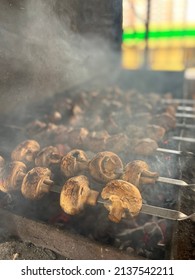 Grilled Mushrooms In A Smoky Grill Closeup. Mushrooms And Meat On Skewers