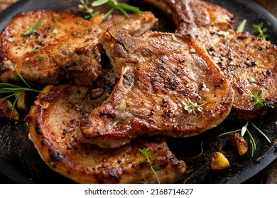 Grilled or pan fried pork chops on the bone with garlic and rosemary - Shutterstock ID 2168714627